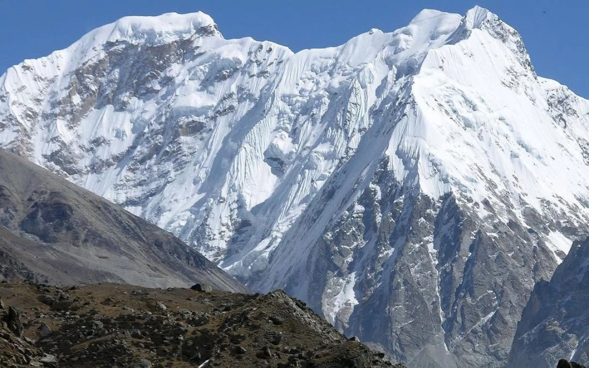 Broad snow and ice face of Tent Peak under clear blue sky