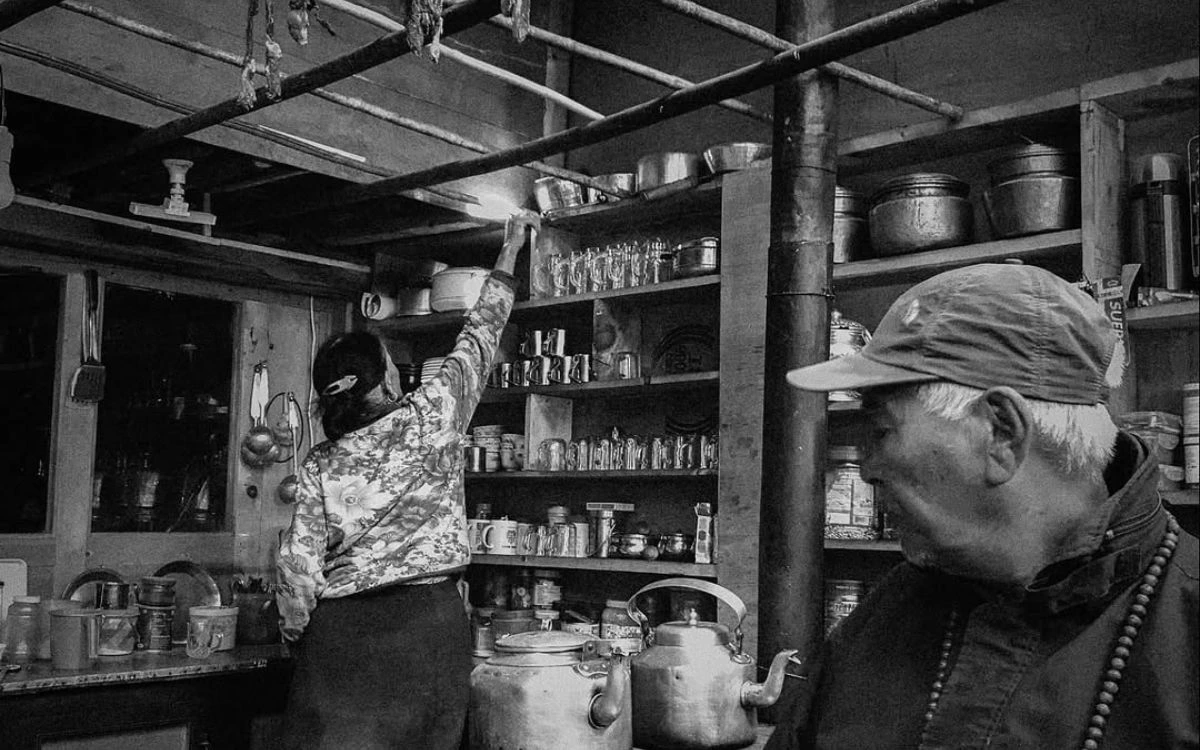 Teahouse kitchen with pots, kettles, and shelves on the Annapurna Circuit
