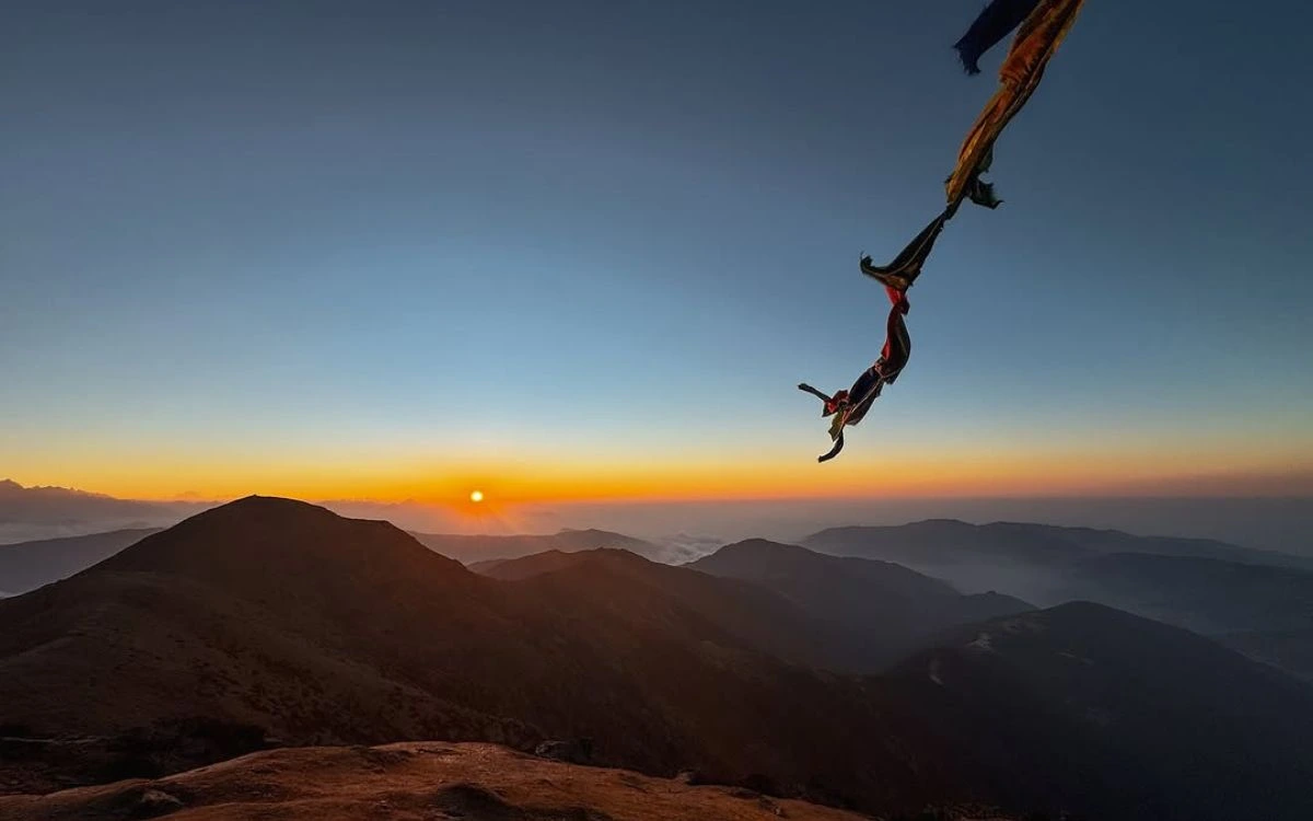 Sunrise view from Pikey Peak summit with prayer flags