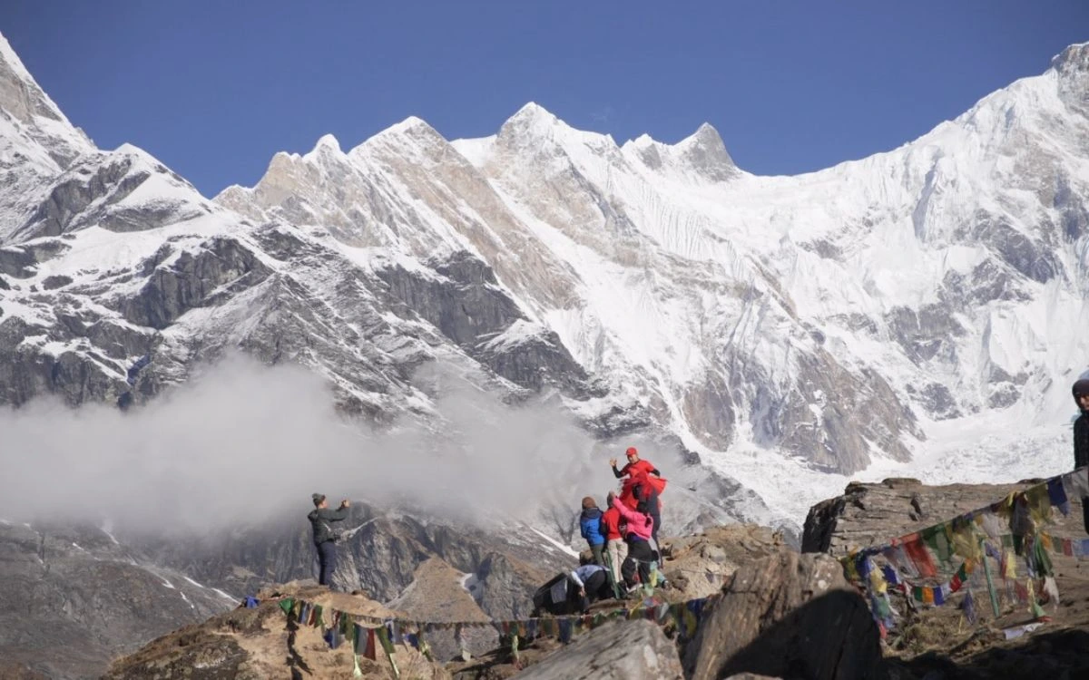 Trekkers at a prayer-flag viewpoint on the Annapurna Base Camp Trek