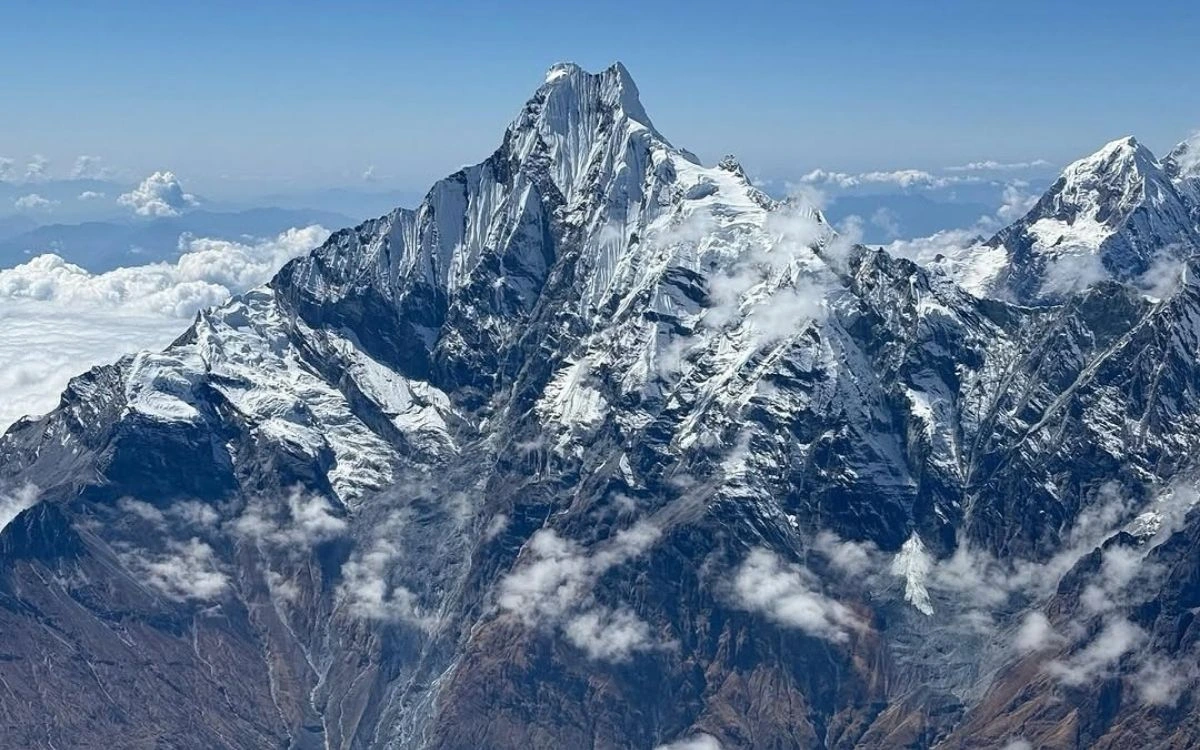 Annapurna peak rising above clouds with dramatic pyramid summit