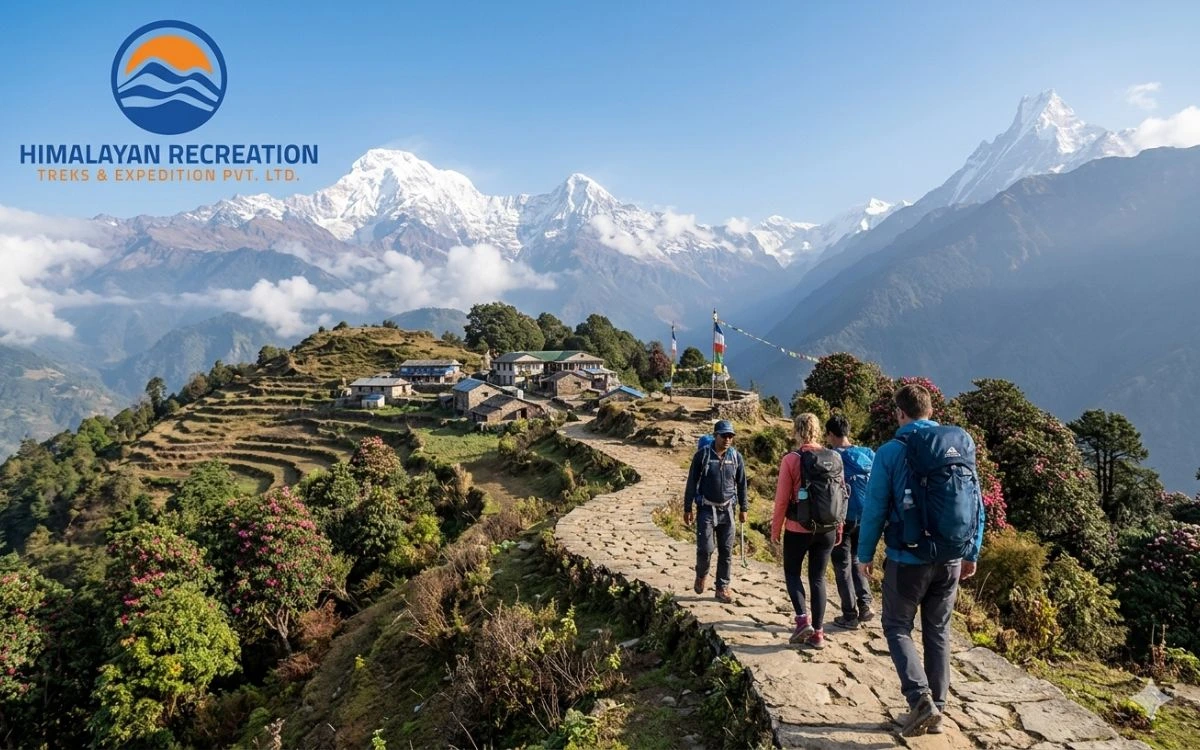 Trekkers on a mountain path next to a village