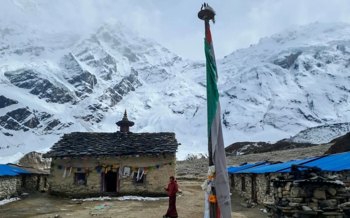 Monk at Pungyen Gompa with Manaslu mountain views