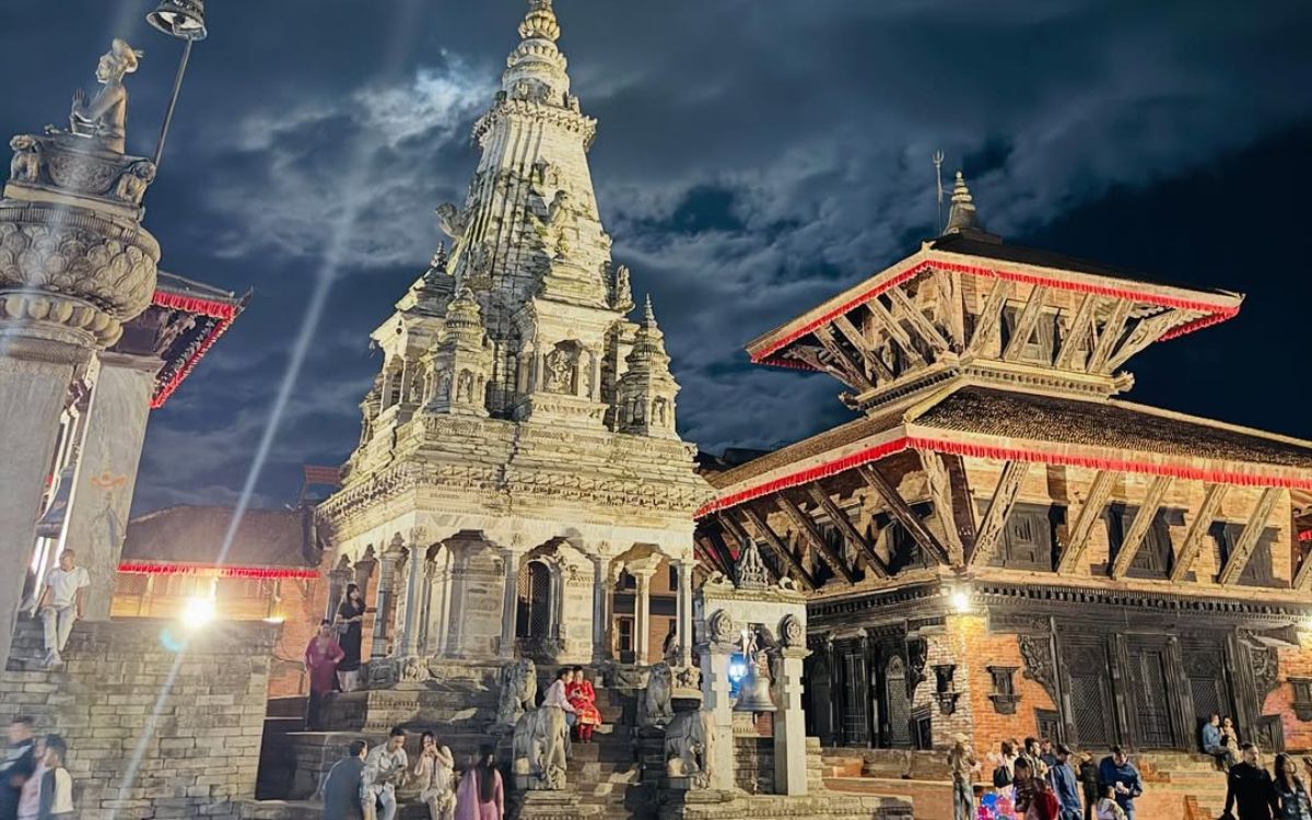 Bhaktapur Durbar Square night view featuring Vatsala Durga Temple and 55 Window Palace with dramatic stormy sky