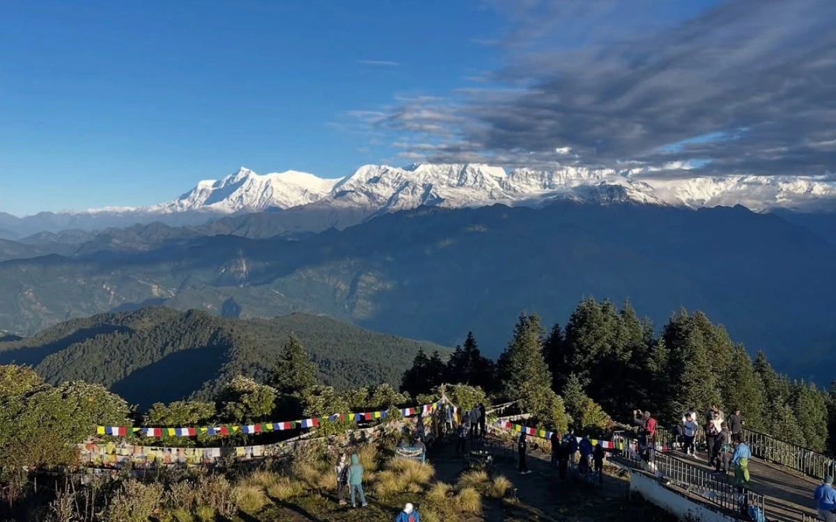 Poon Hill viewpoint with prayer flags overlooking Annapurna mountain range Nepal