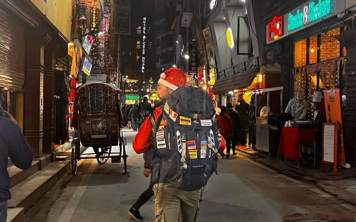 Traveler with Santa hat exploring festive Thamel streets during Christmas in Nepal