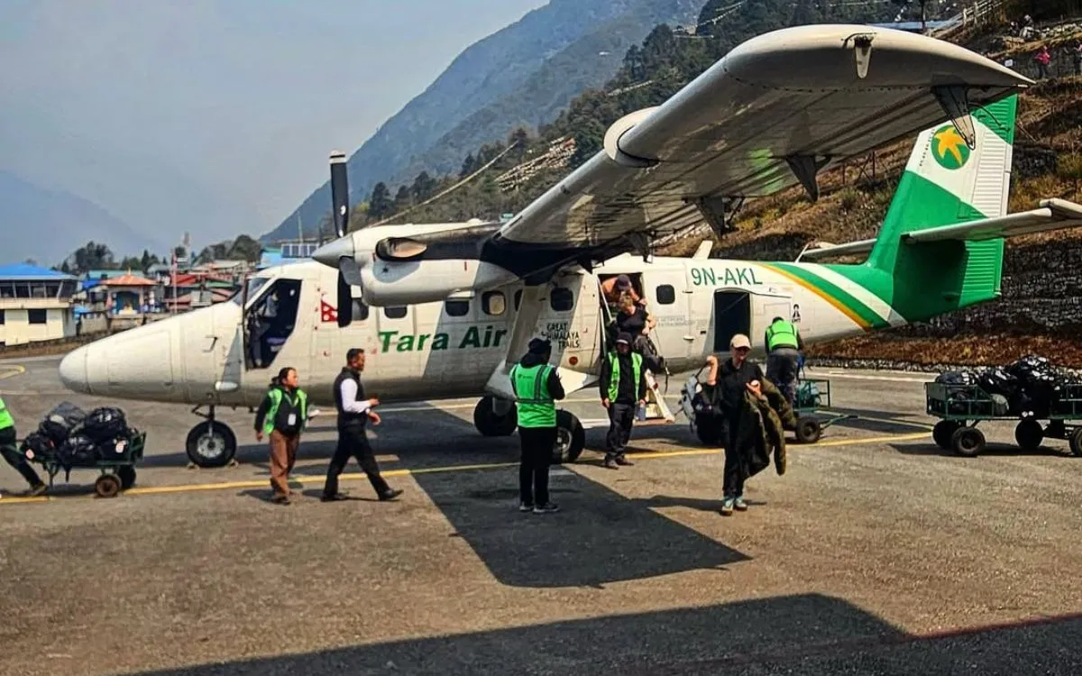 Tara Air passengers boarding Twin Otter plane at remote Himalayan airstrip in Nepal