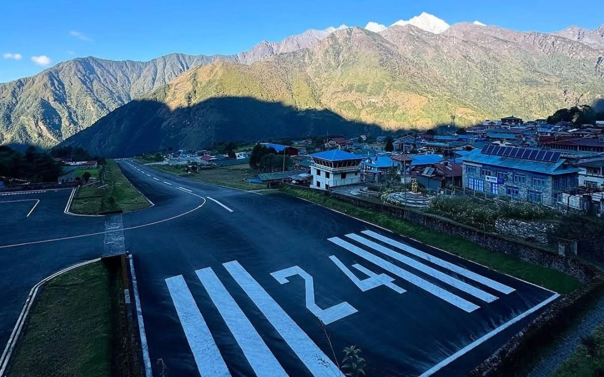 The famous Tenzing-Hillary Airport runway at Lukla with the Khumbu valley and mountains behind