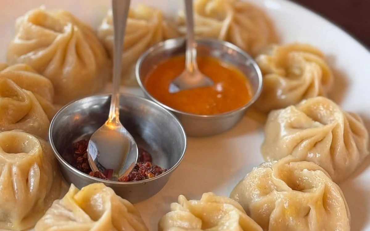 Momo (Nepali dumplings) with tomato and spicy dipping sauces