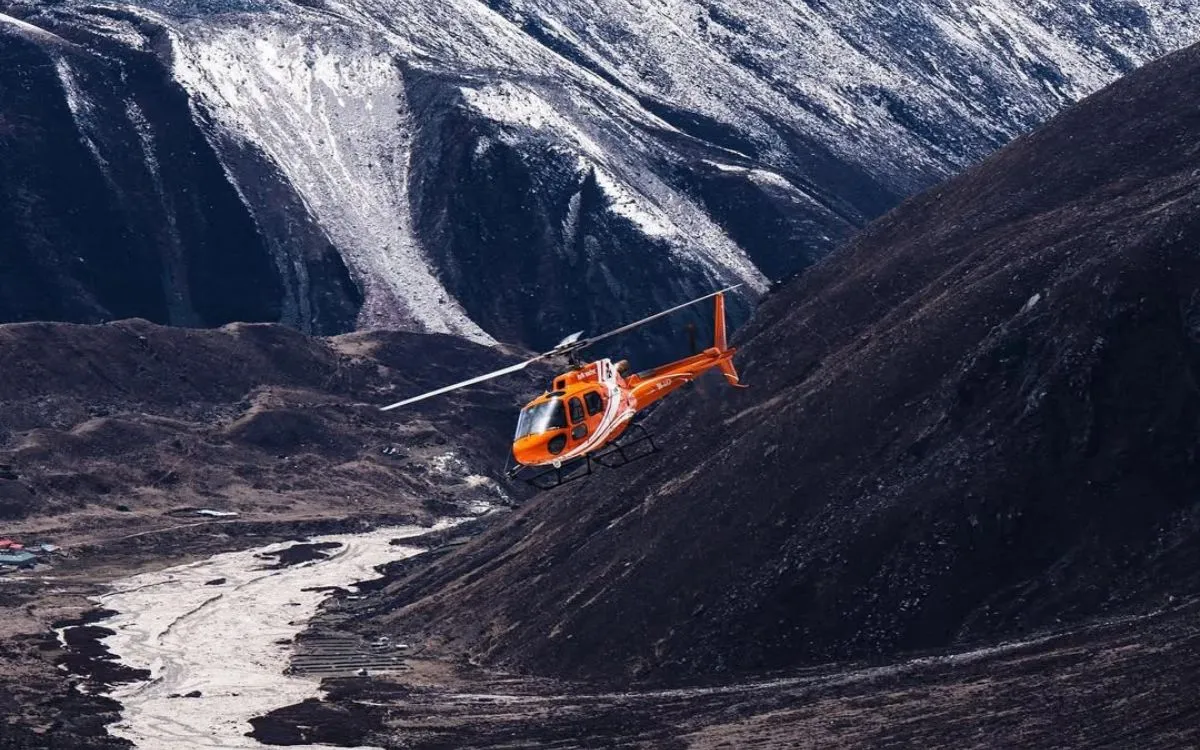 Manang Air rescue helicopter on a snowy helipad in the Nepal Himalayas
