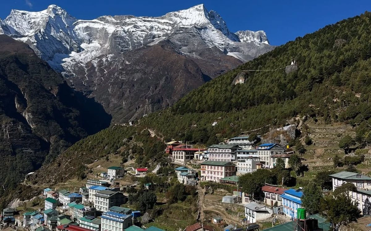 Namche Bazaar village nestled on a hillside with Himalayan peaks behind