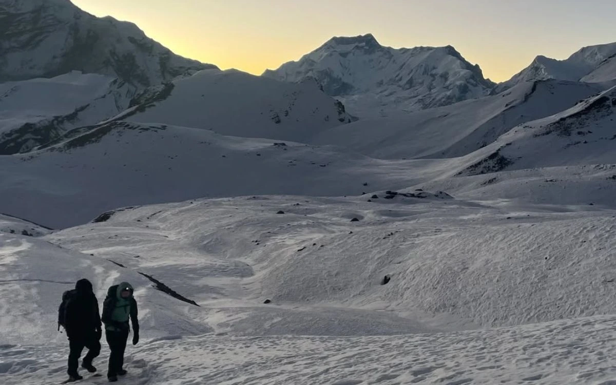 Trekkers hiking at Thorong La Pass on Annapurna Circuit trek Nepal