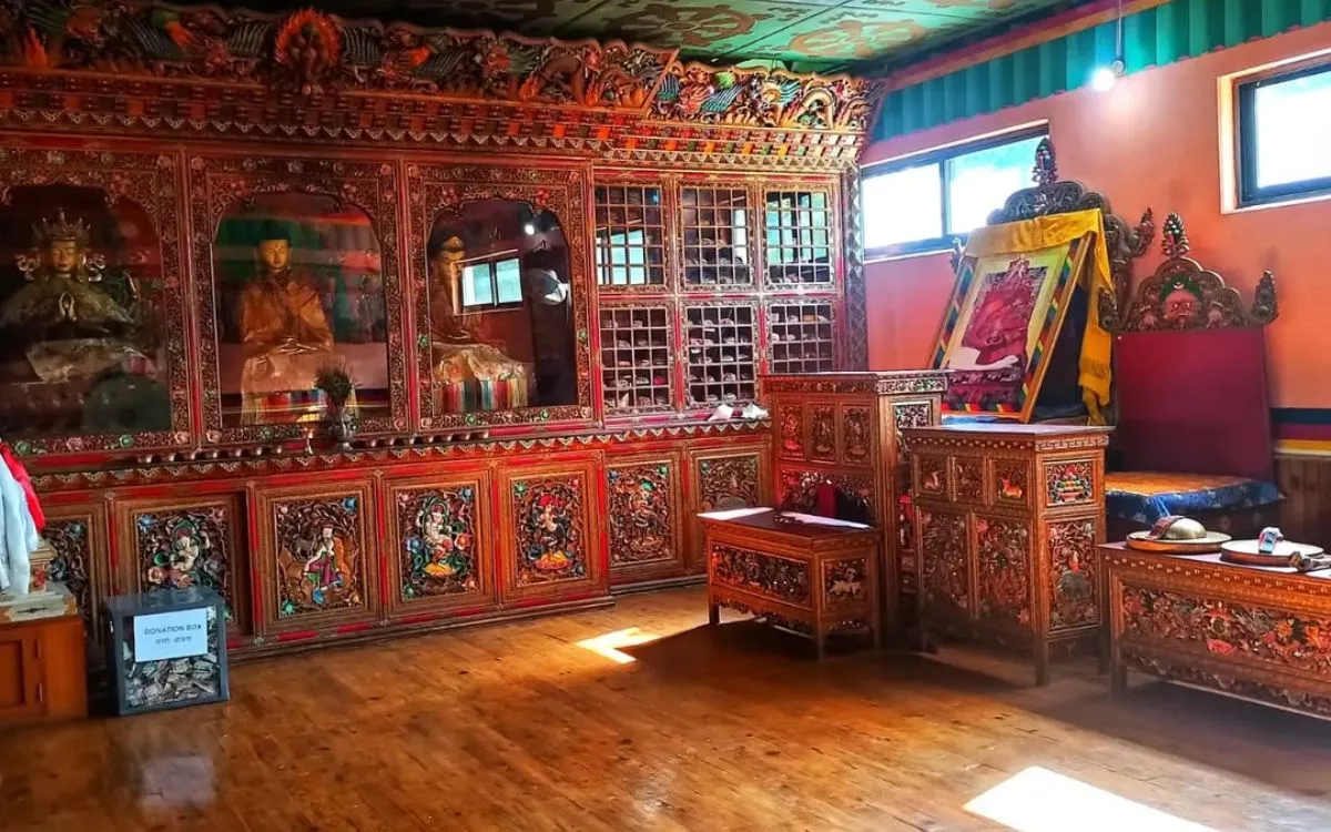 Ornate Tibetan Buddhist altar with carved woodwork in museum cultural exhibit