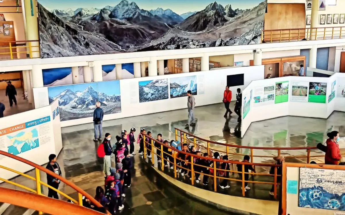 Visitors viewing Himalayan photography exhibits in International Mountain Museum main hall