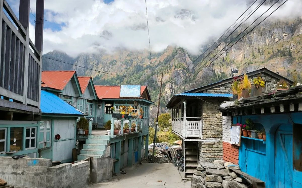 A quiet village street with colorful teahouses and stone buildings on the Annapurna Circuit trek
