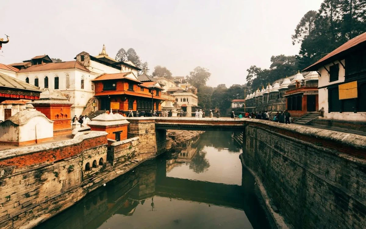 Pashupatinath Temple complex with traditional architecture reflected in sacred river