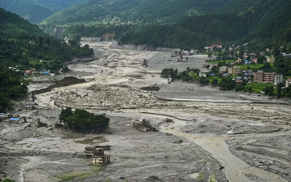 Flood debris and damaged buildings in a Nepal river valley after the flash flood