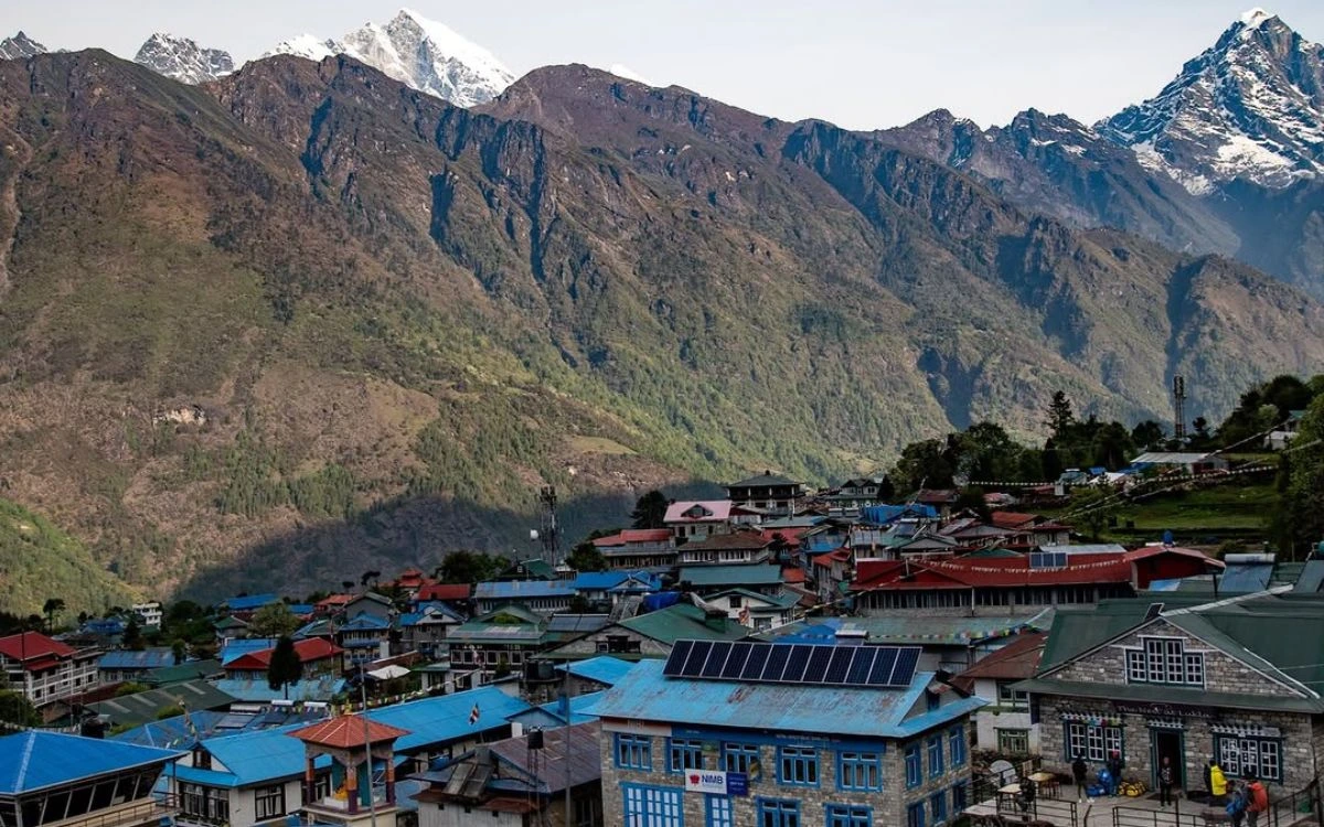Namche Bazaar village with peaks rising behind trekking lodges