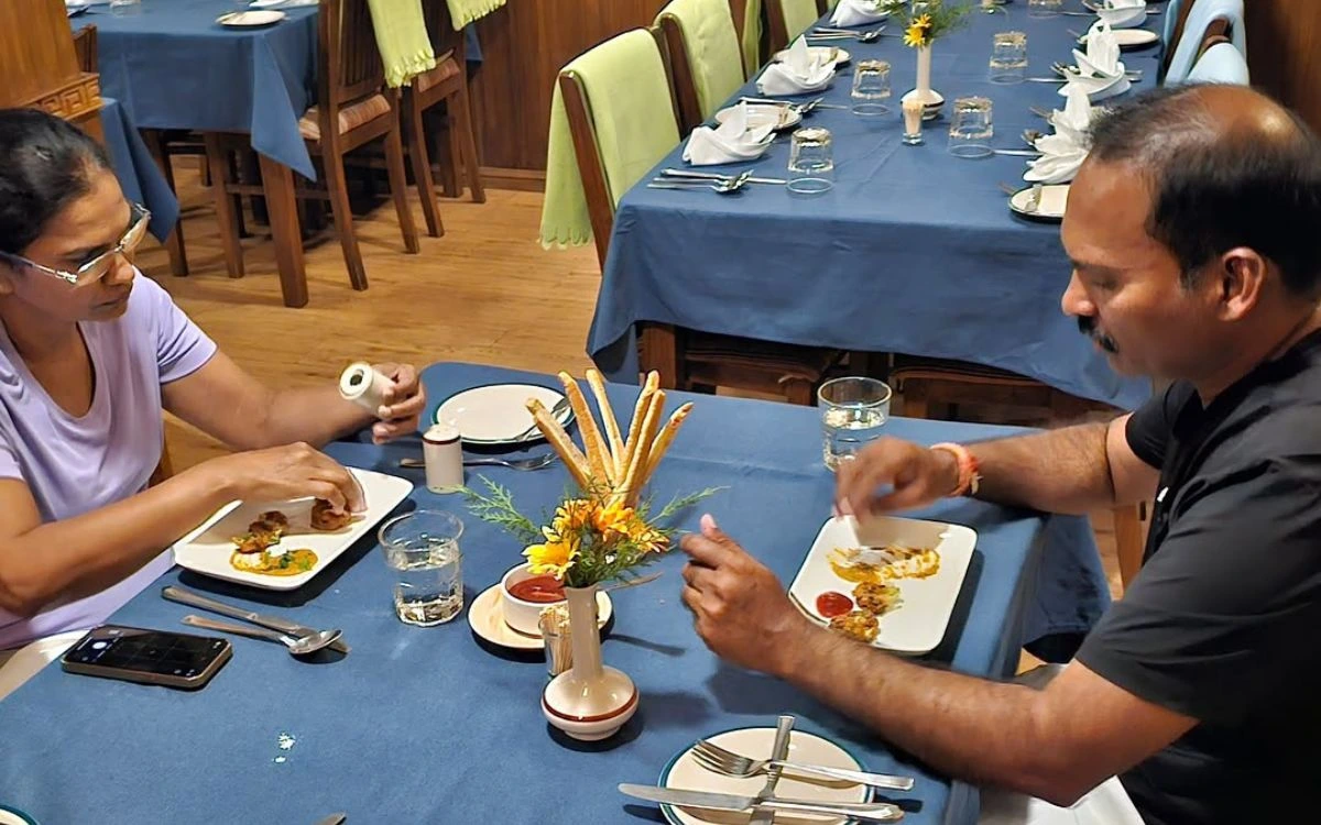 Trekkers enjoying a plated meal at a lodge restaurant in Nepal
