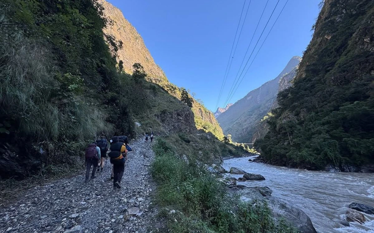 Trekkers walking along Budhi Gandaki River trail towards Manaslu Circuit