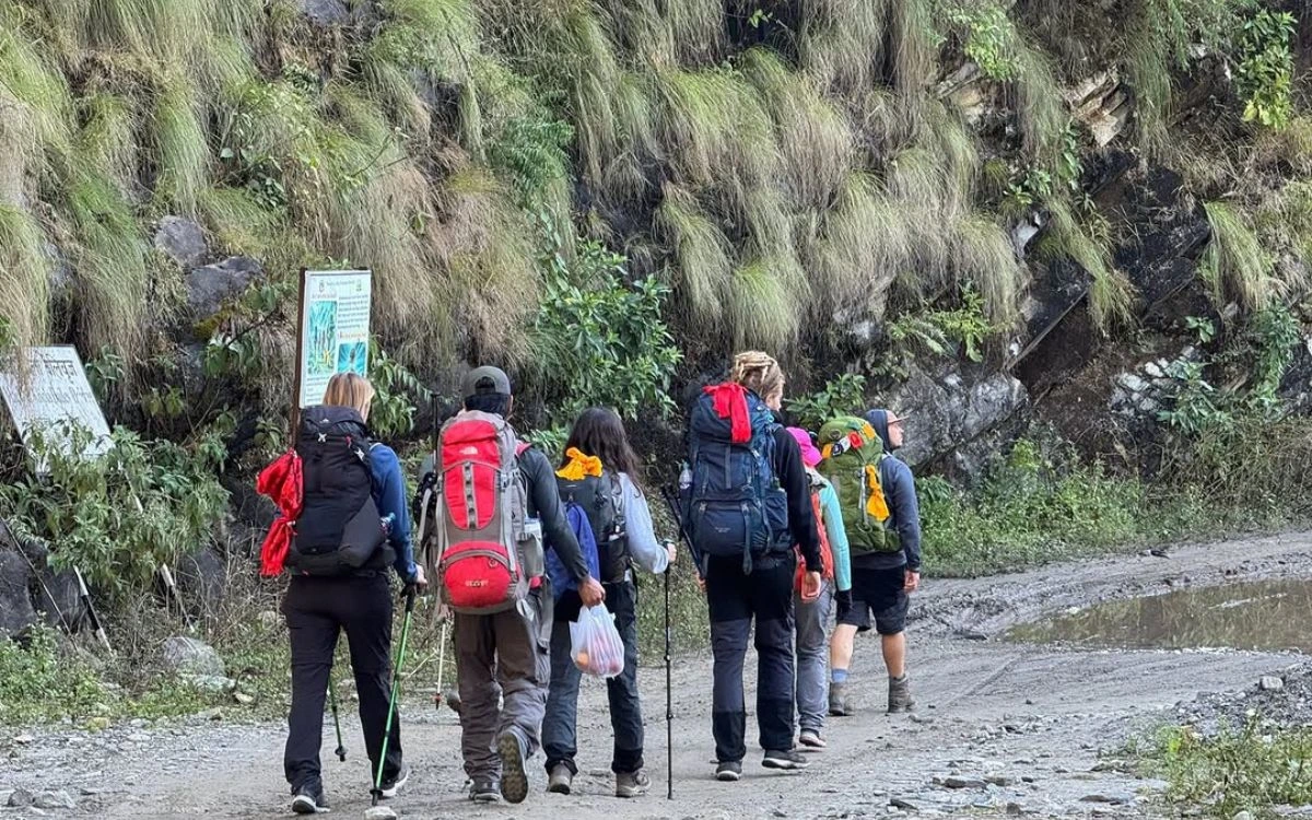 Group of trekkers with backpacks beginning Manaslu Circuit trek from Machha Khola