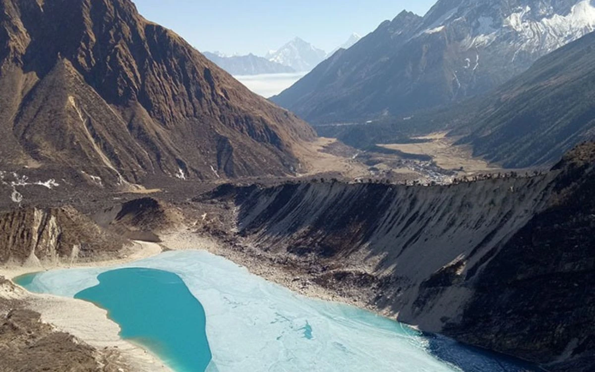 Turquoise Birendra Lake surrounded by dramatic mountain valleys in the Manaslu region