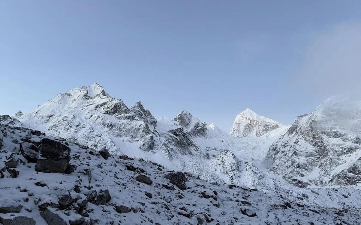 Snow-covered Himalayan peaks under overcast winter sky