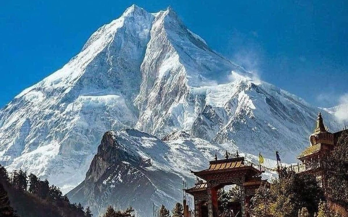 Mount Manaslu peak towering above a Tibetan Buddhist monastery