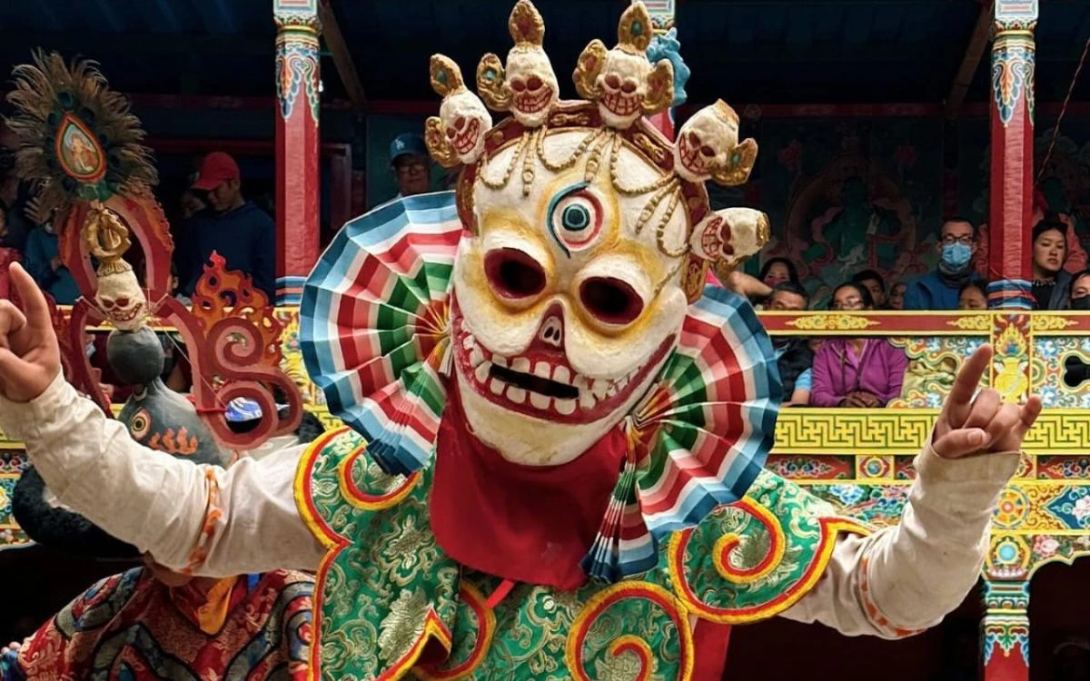 Monk in a skull mask performing the Cham dance