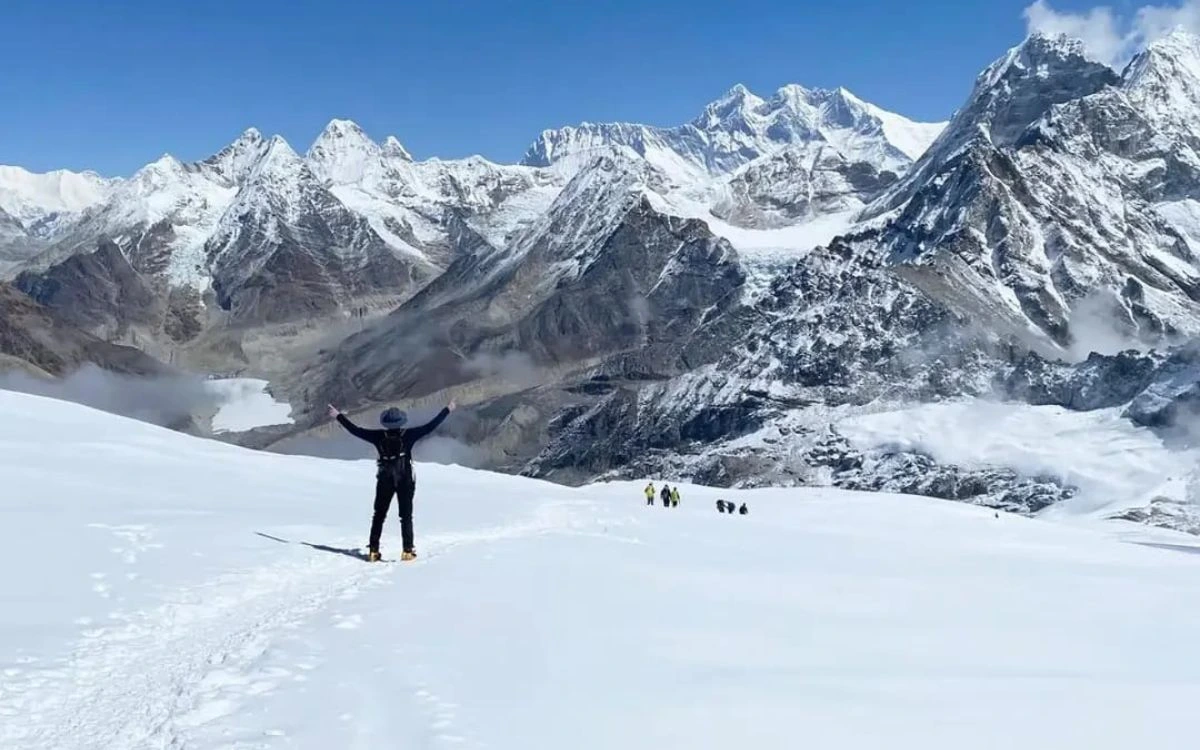 Climber celebrating on the snowfield route to Mera Peak