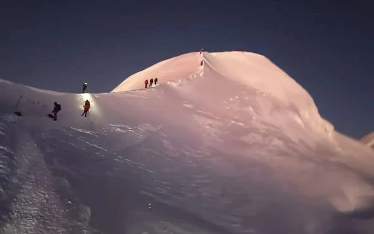 Climbers ascending Mera Peak's summit ridge before dawn