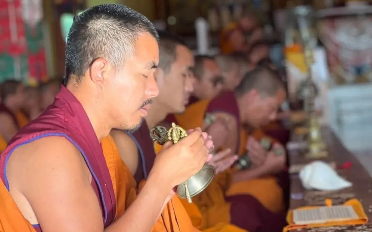 Buddhist monk performing ritual ceremony at Namobuddha monastery