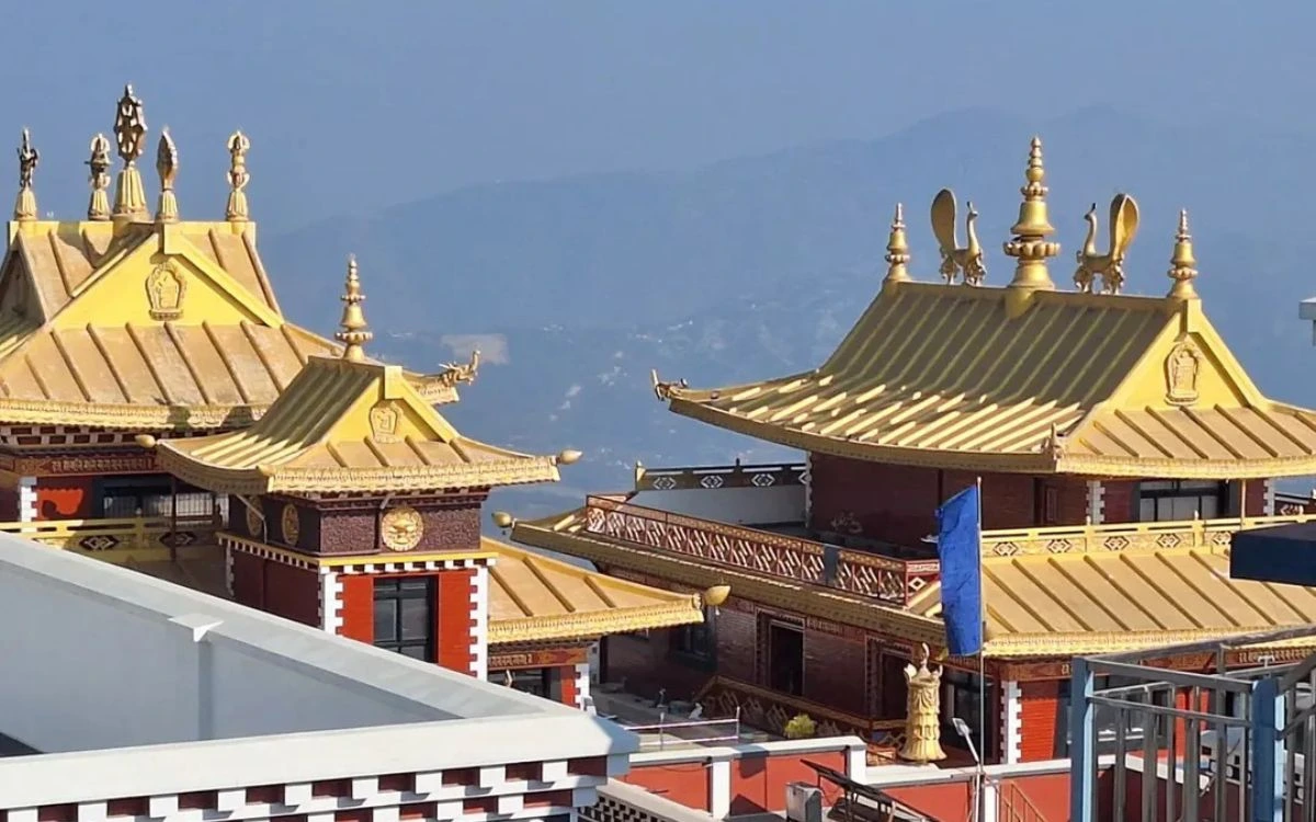 Golden rooftops of Namobuddha monastery with mountain backdrop