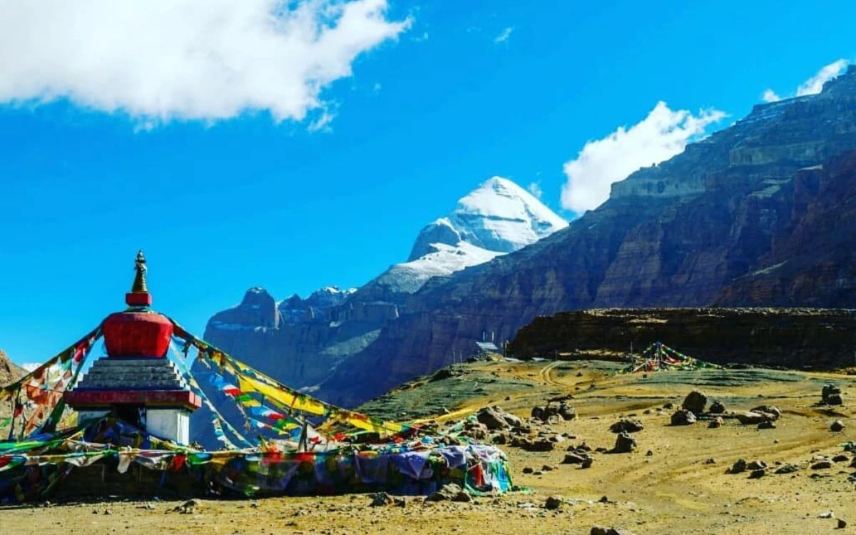 Stupa and prayer flags with Mount Kailash in the distance