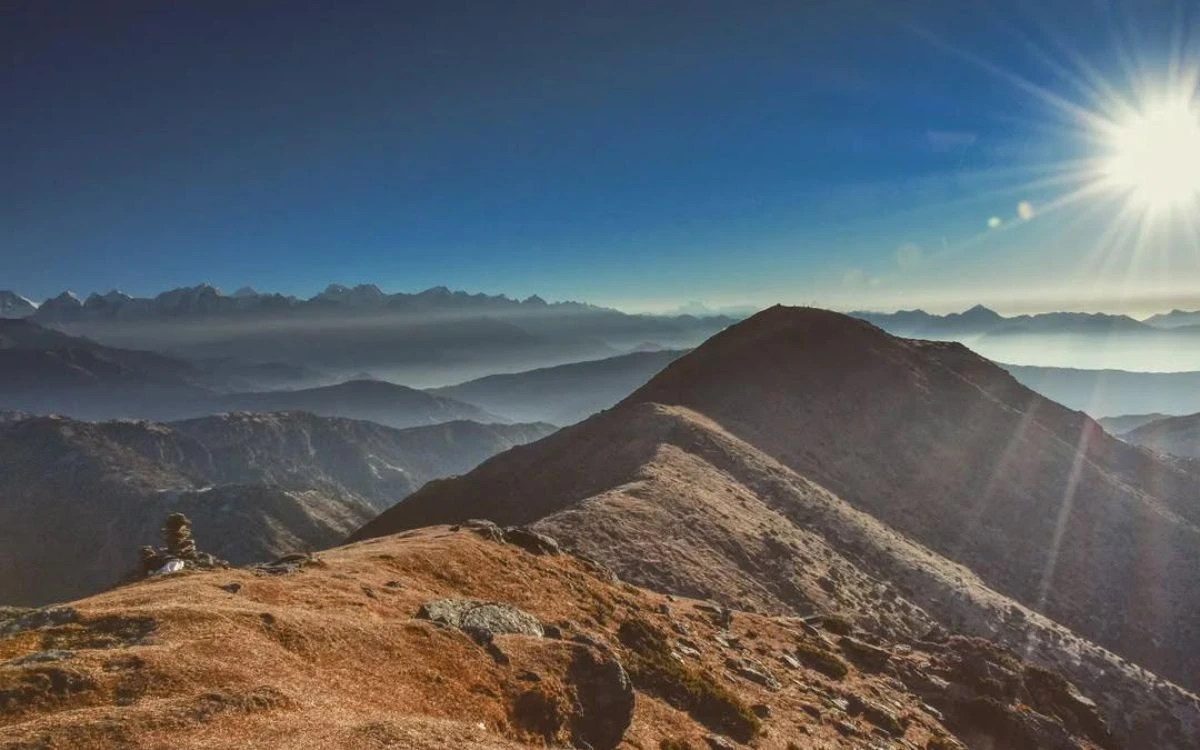 Golden sunrise light on Pikey Peak ridgeline with layered mountain ranges