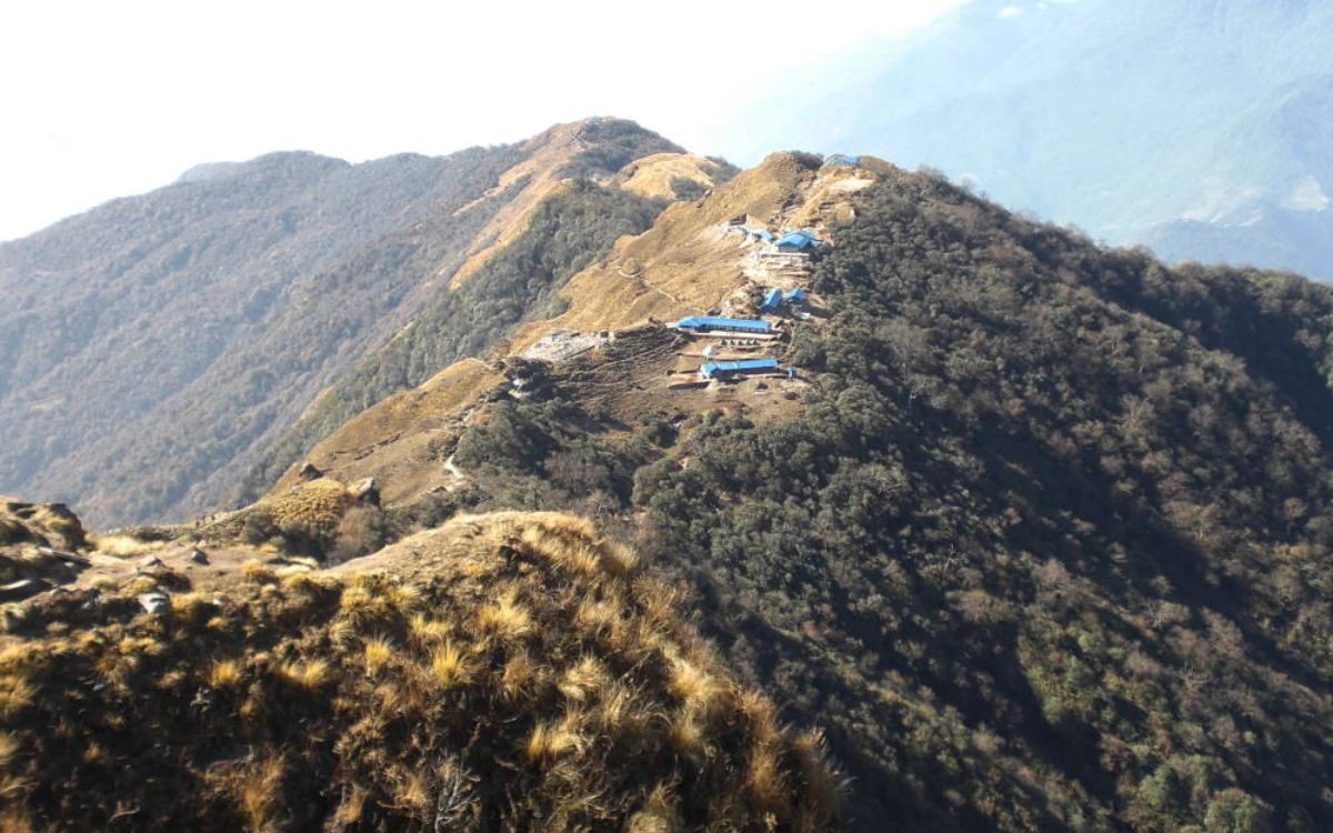 Blue-roofed teahouses perched on a ridge at Mardi Himal High Camp