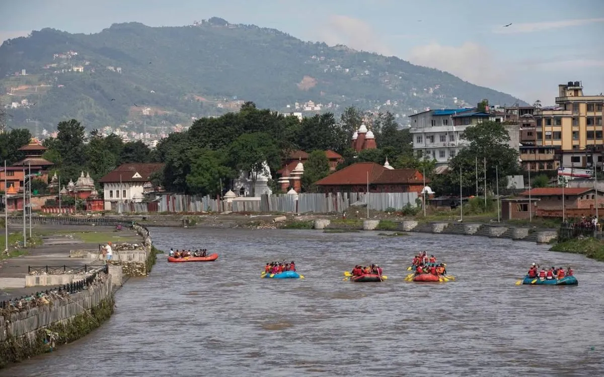White-water rafting on Bagmati River in Kathmandu with temple backdrop
