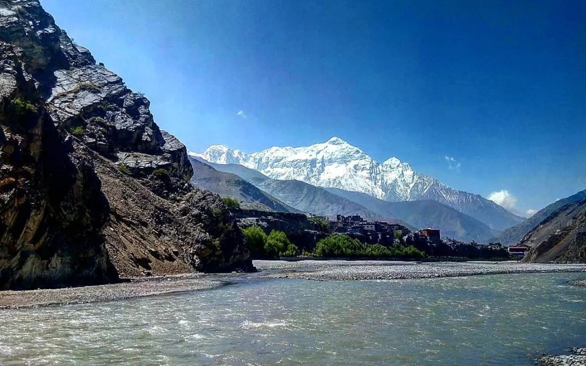 Gandaki River flowing through mountain valley with snow-capped Himalayas