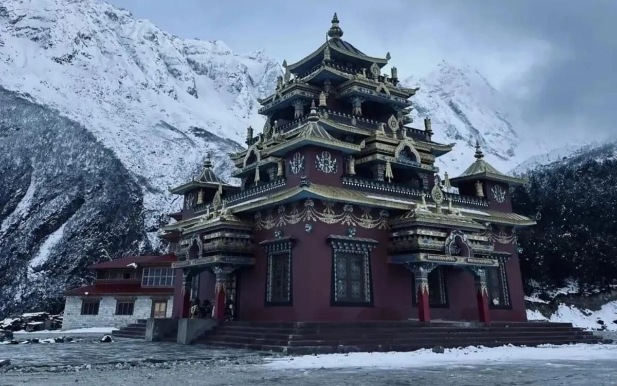Ornate monastery in Manaslu region with snow-capped peaks behind