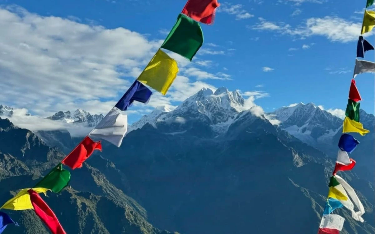 Prayer flags fluttering against a backdrop of Nepal's mountains