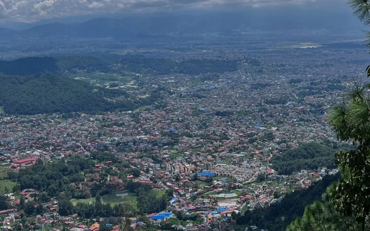 Aerial panoramic view of Kathmandu Valley cityscape from Shivapuri Peak (2,732 meters) under dramatic clouds, 