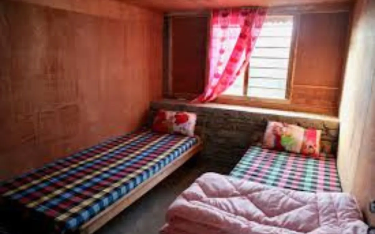 Simple teahouse sleeping room with colorful bedding and curtains