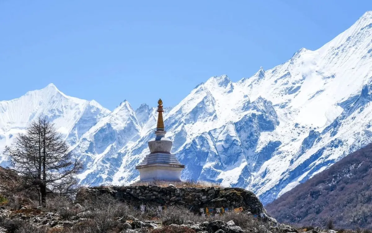 Buddhist stupa with snow-capped Himalayan peaks in Langtang Valley