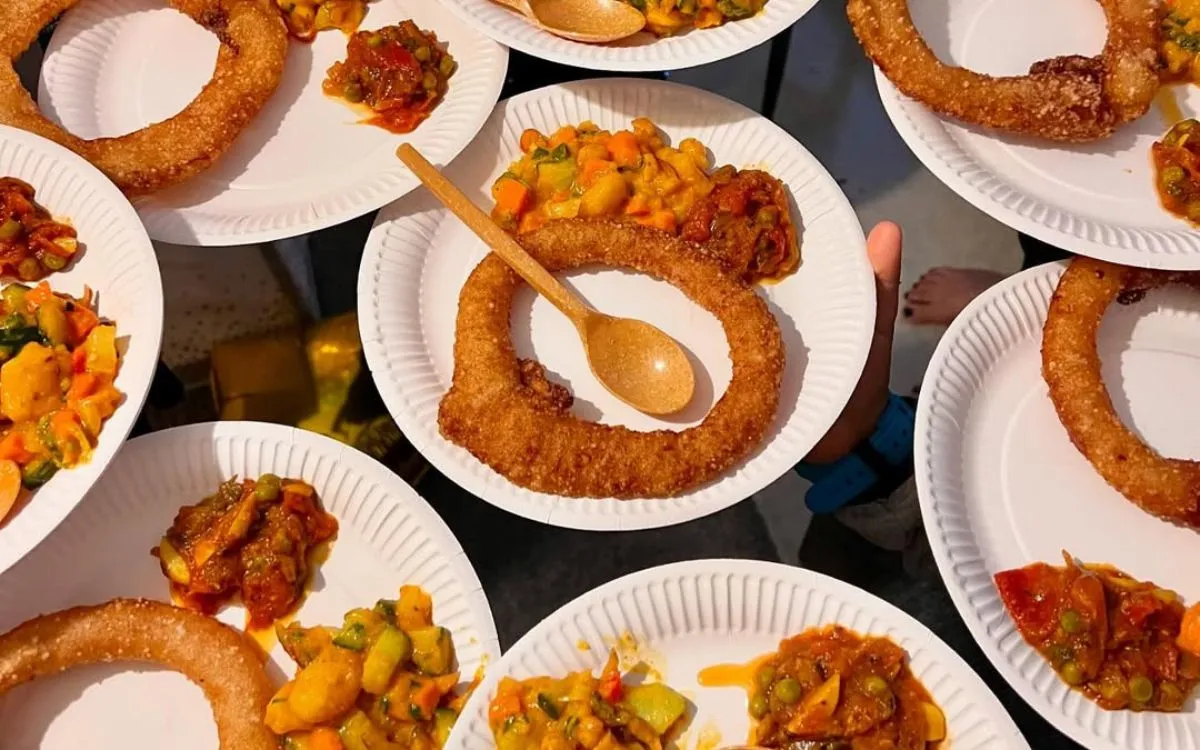 Traditional Nepali sel roti sweet bread rings served with achar pickle on white plates for Tihar festival celebration