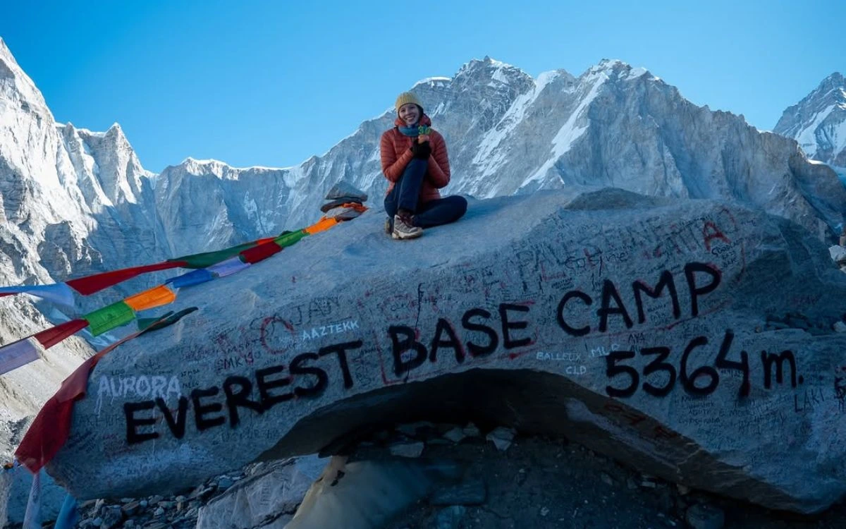 Trekker at the Everest Base Camp 5,364m marker stone