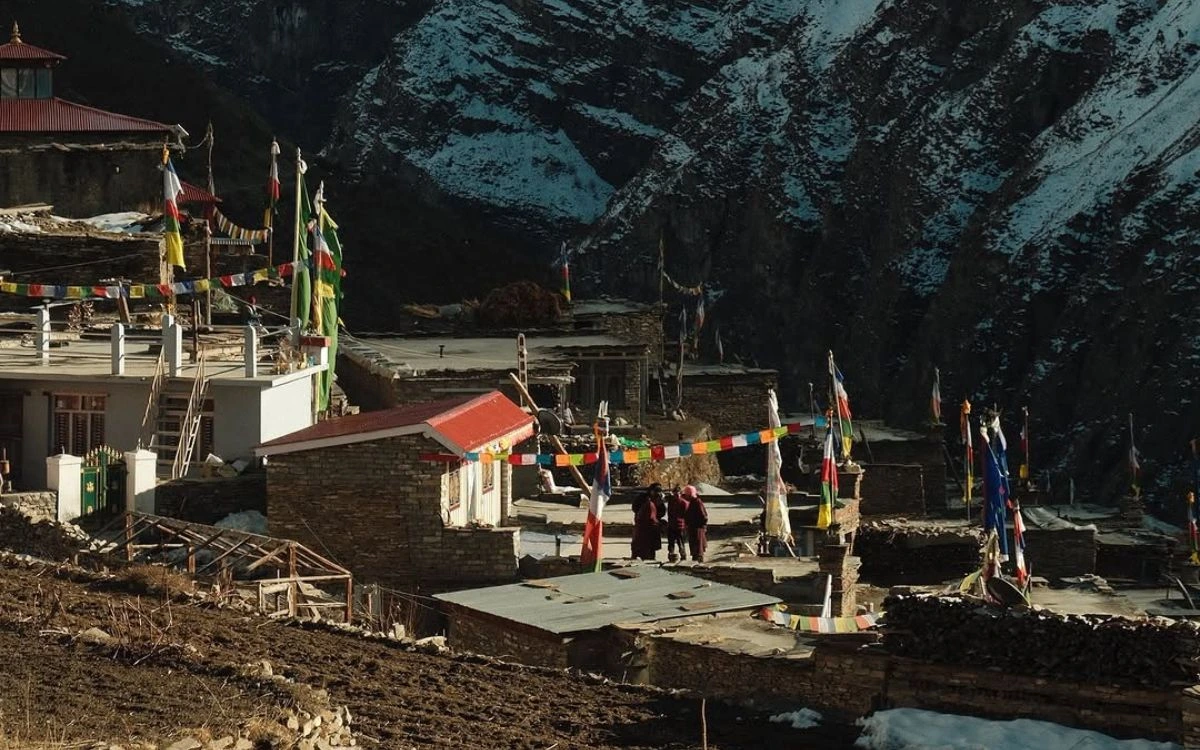 Prayer flags and stone village in Nar Phu Valley during a Nepal trek in August