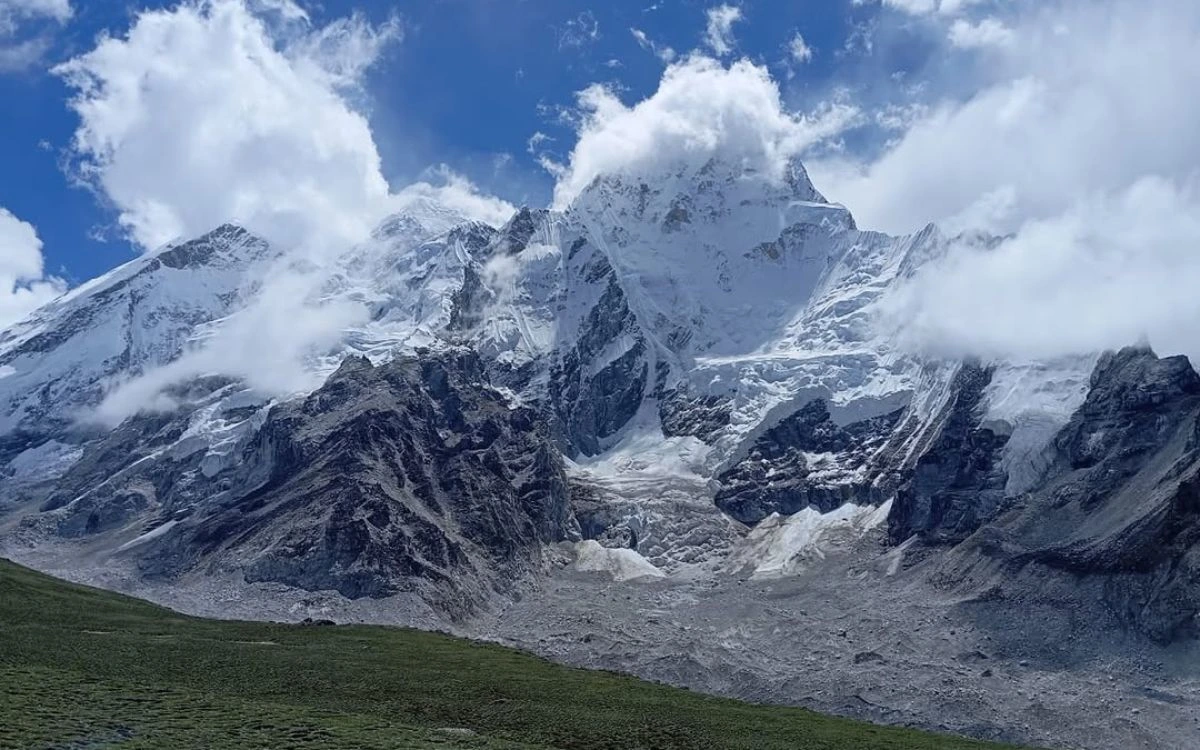 Snow-covered Himalayan peaks wrapped in monsoon clouds during August trekking in Nepal