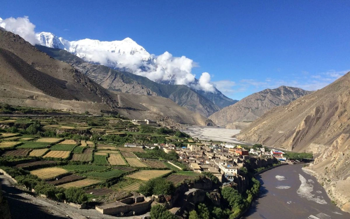 Green terraced fields and river valley on a rain-shadow trekking route in Nepal in August