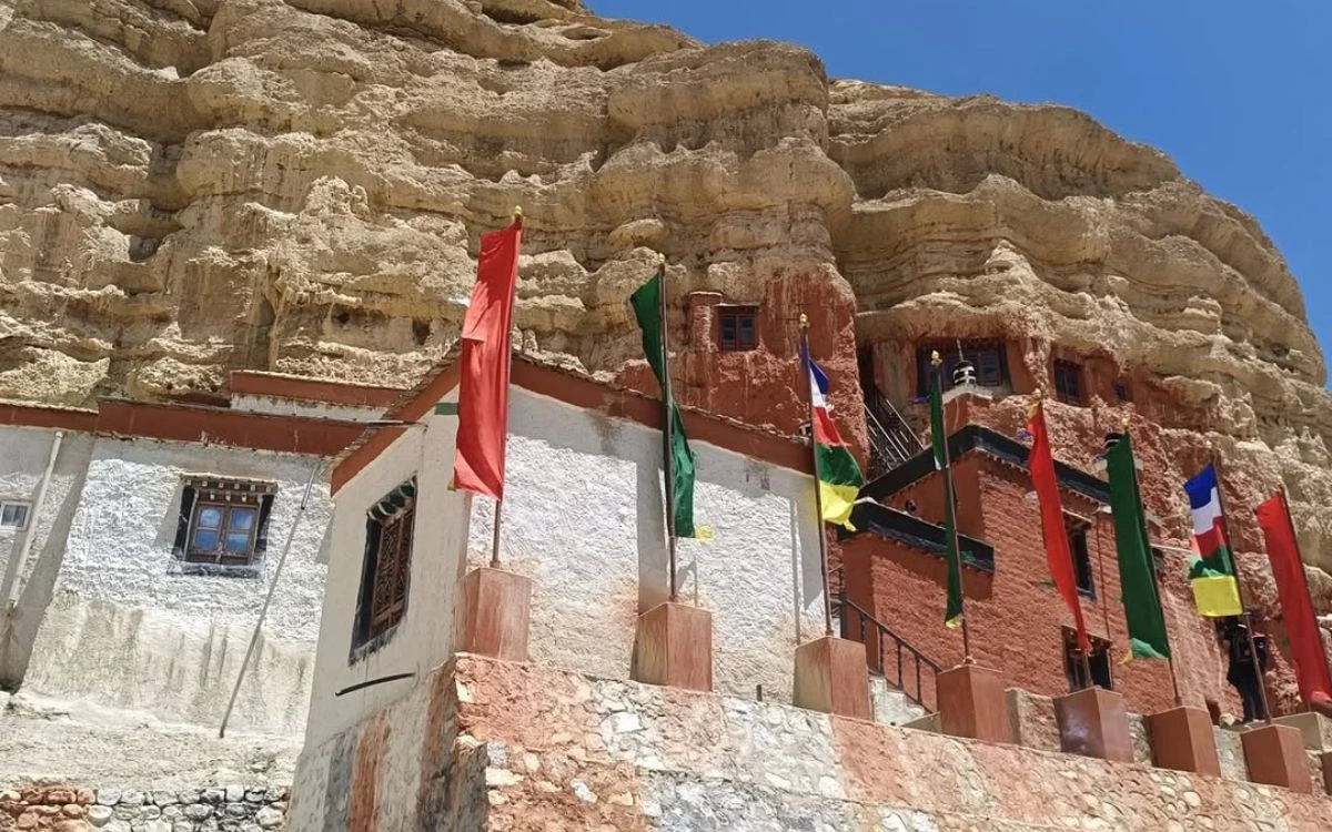 Cliff-face monastery with colorful ceremonial flags in Upper Mustang