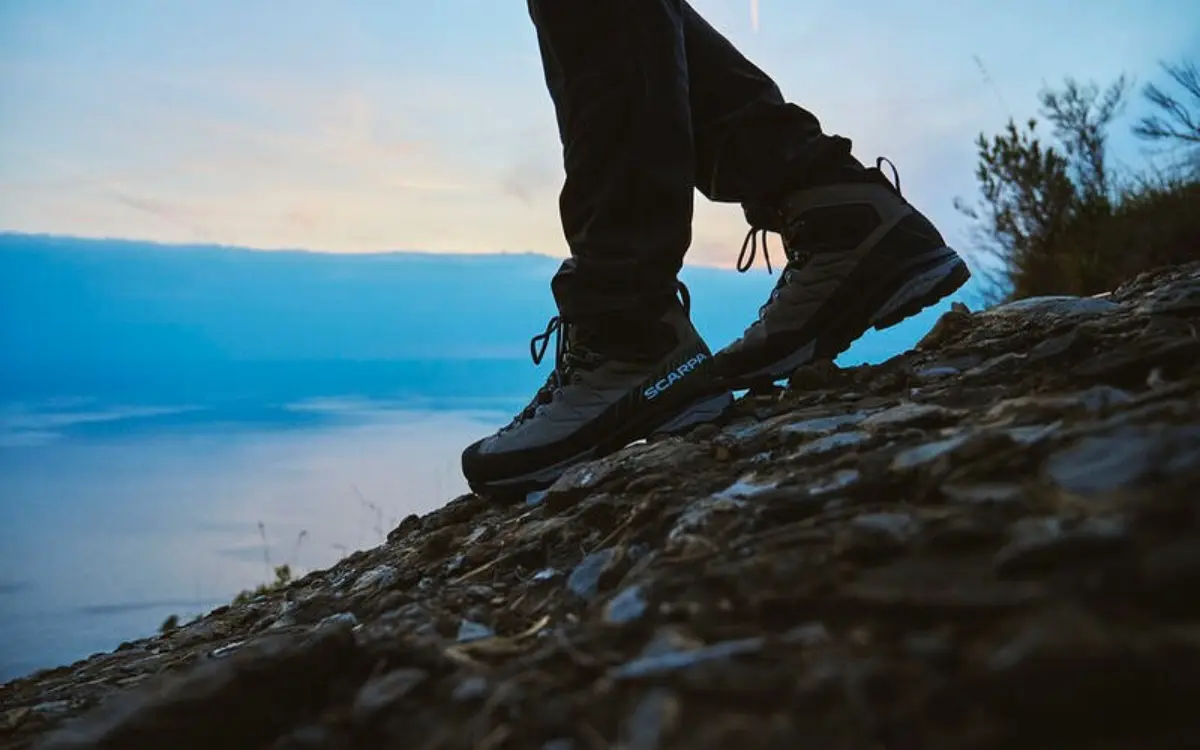 Scarpa mountaineering boots on rocky terrain at sunset